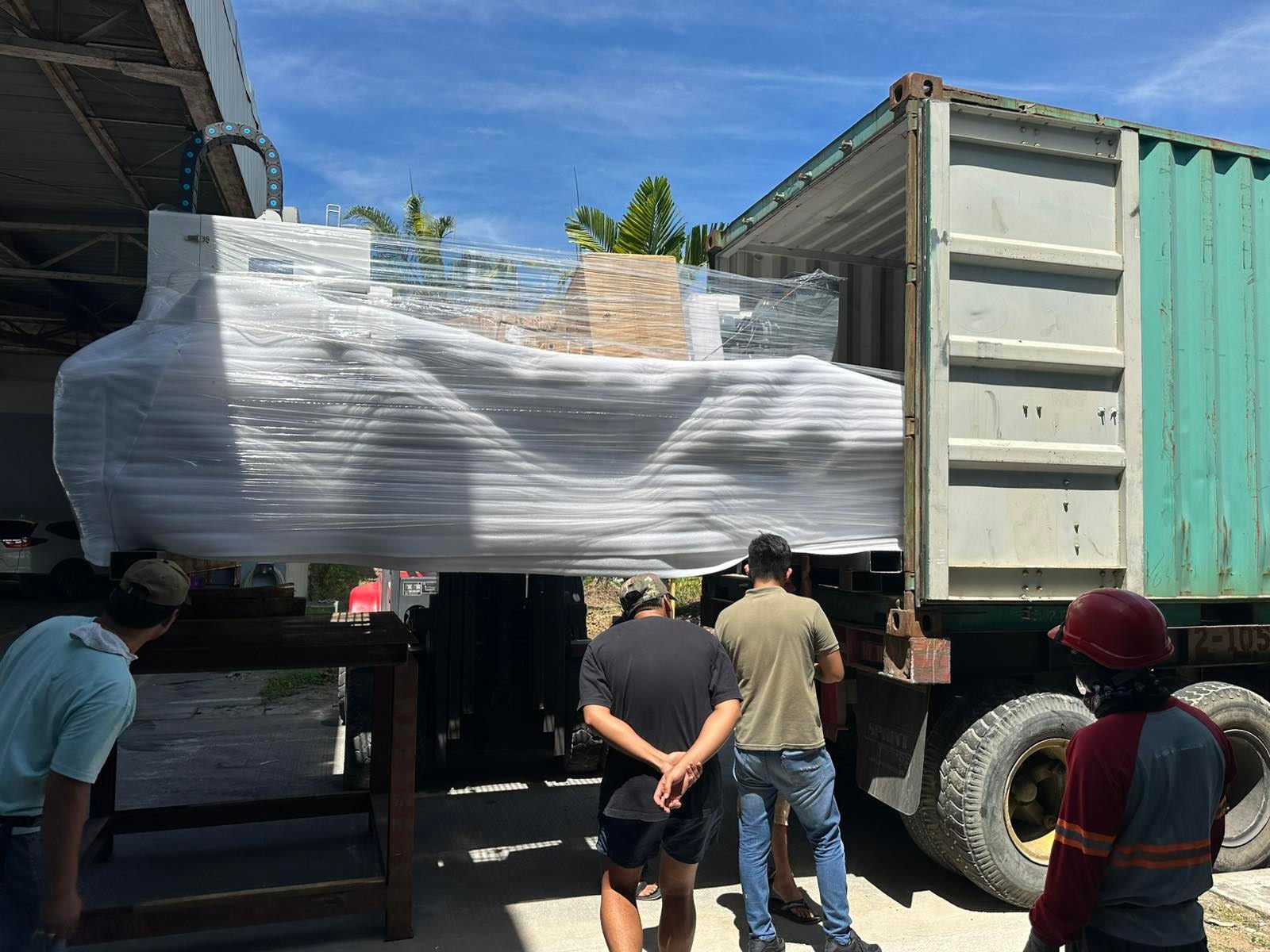 Men loading Wrapped Items Into a Container Truck Outdoors on A Sunny Day — Kerubin Logistics Inc in the Philippines