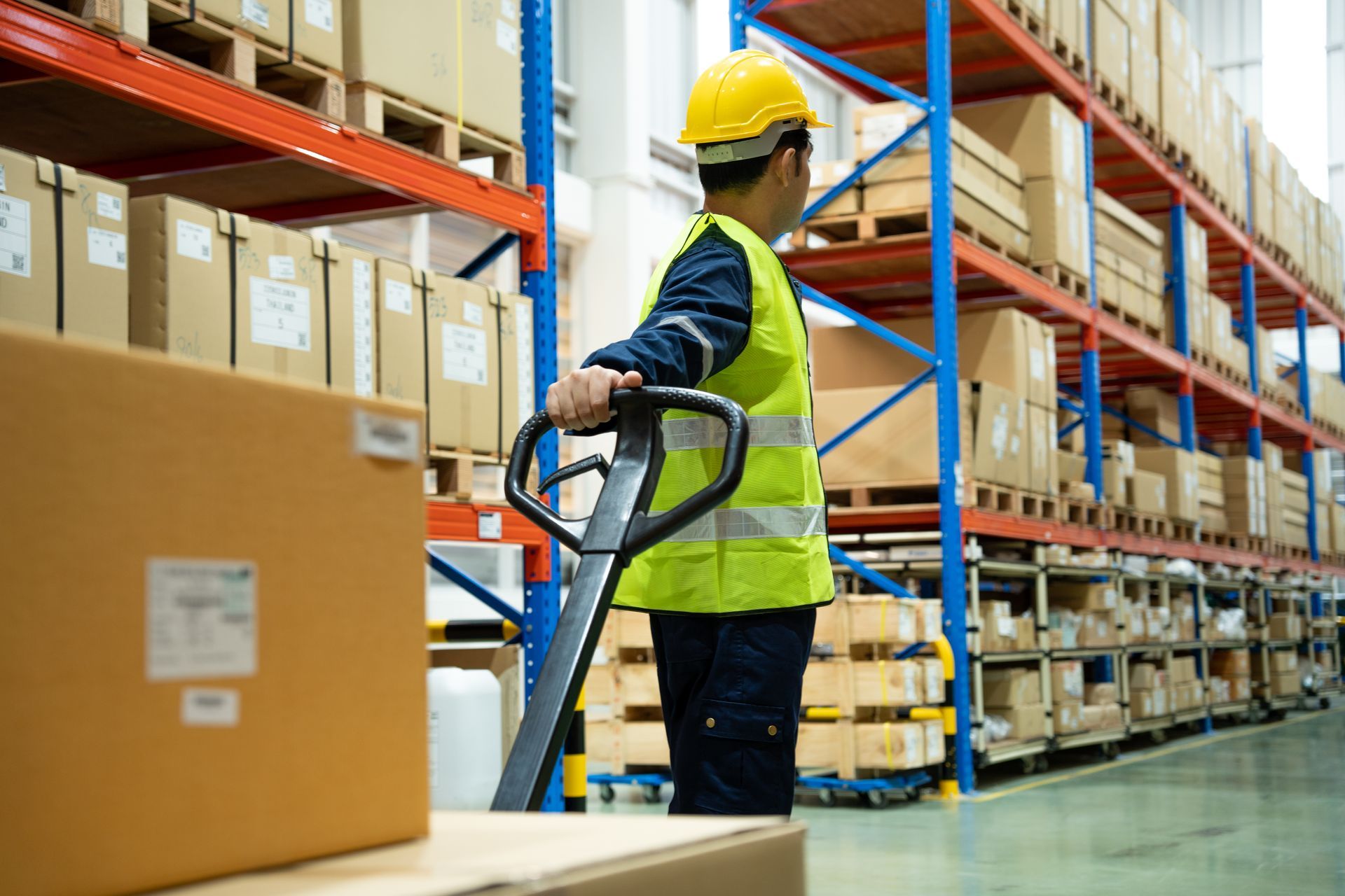 Warehouse worker Using a Pallet Jack to Move a Box — Kerubin Logistics Inc in the Philippines