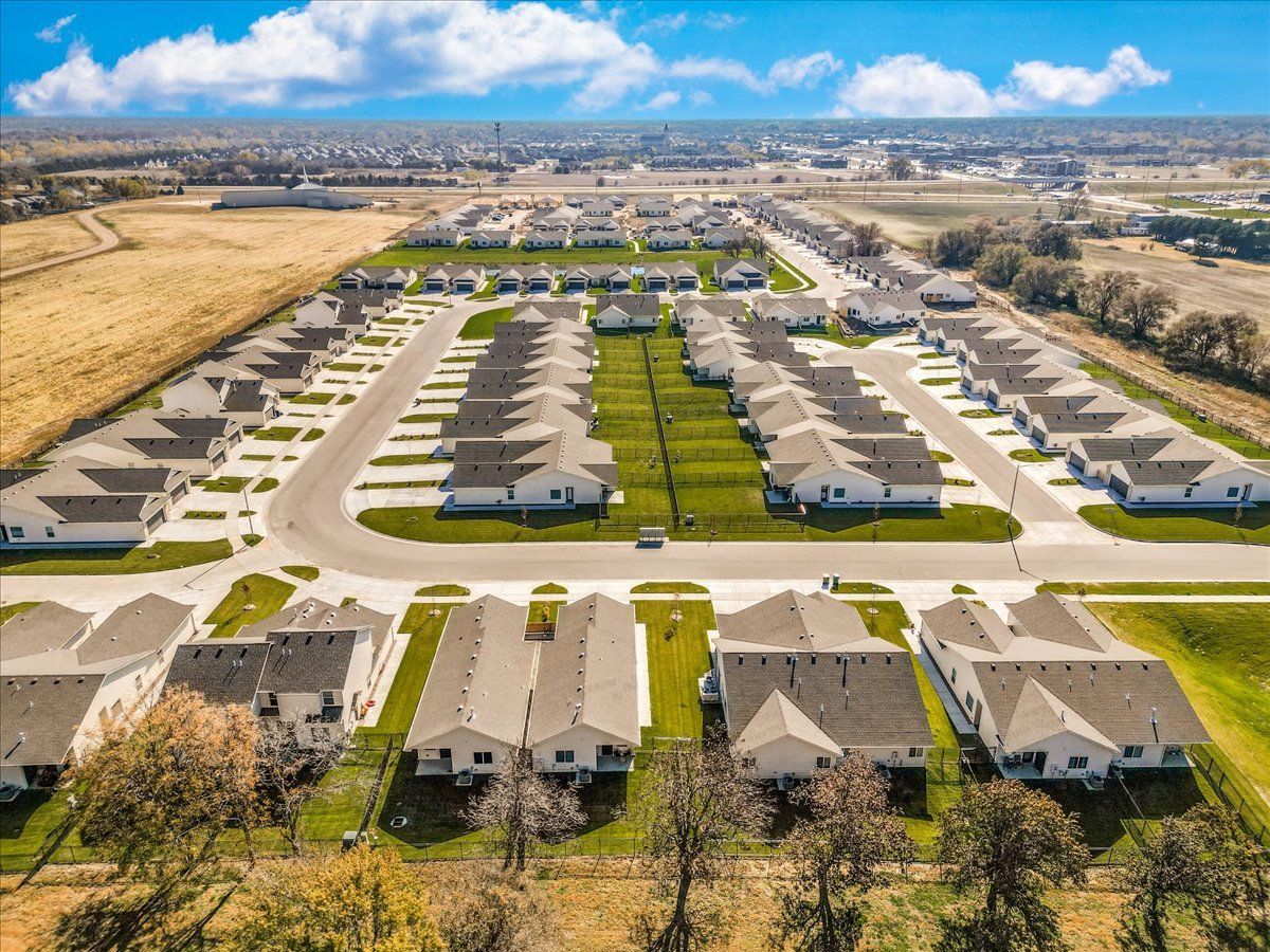 An aerial view of a residential neighborhood with lots of houses and trees.