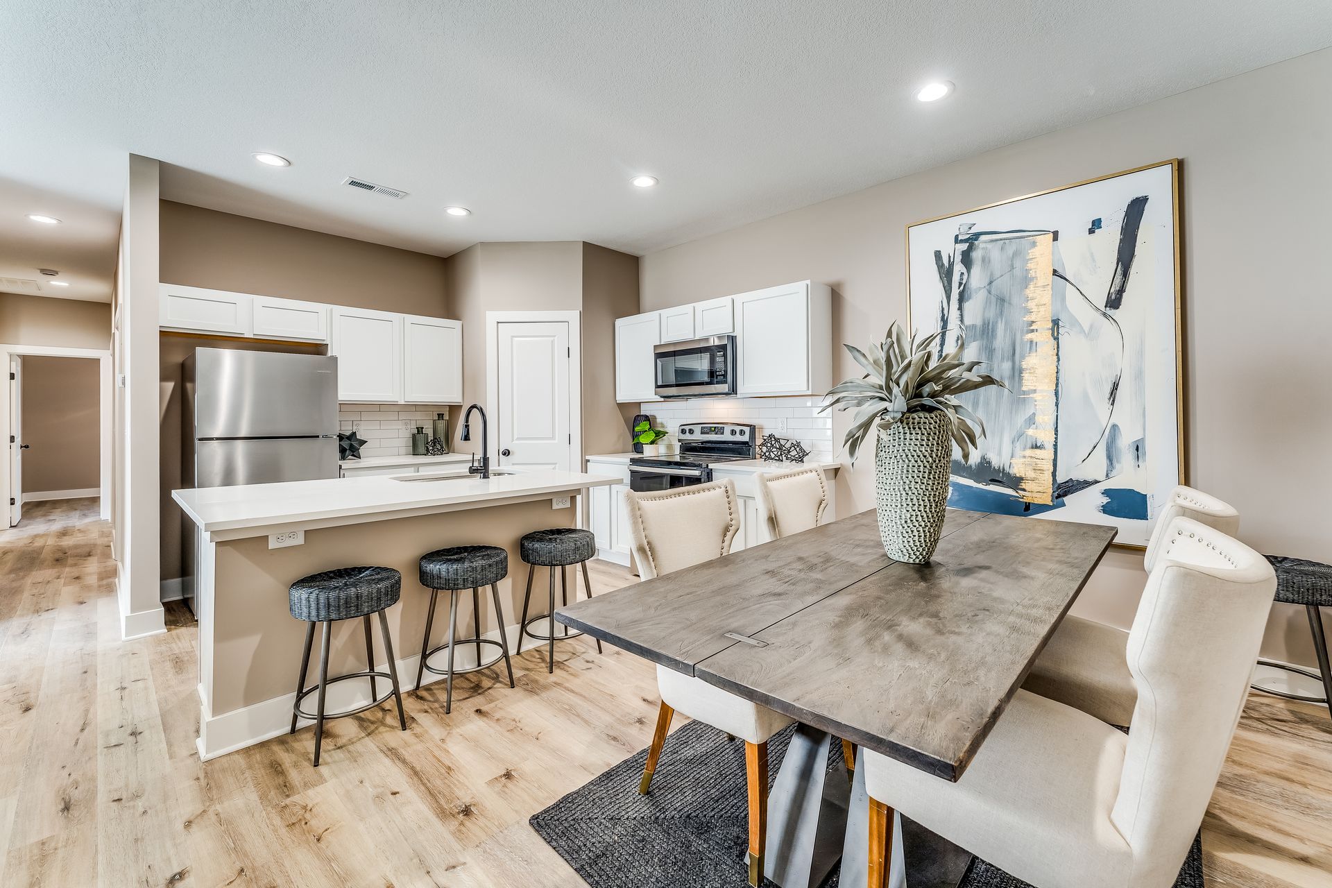 A kitchen and dining room in a house with a table and chairs.