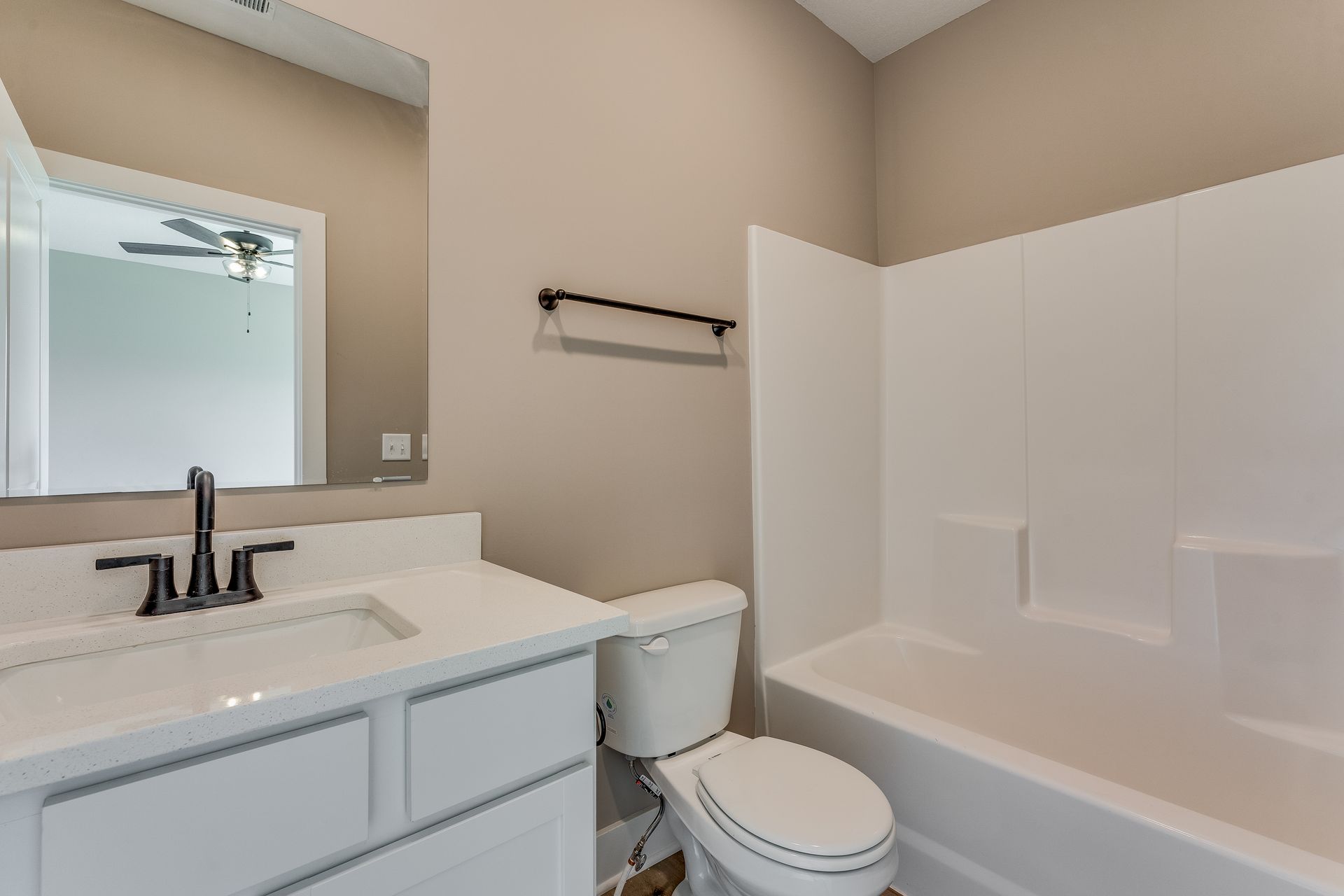 A bathroom with a toilet , sink , and bathtub.