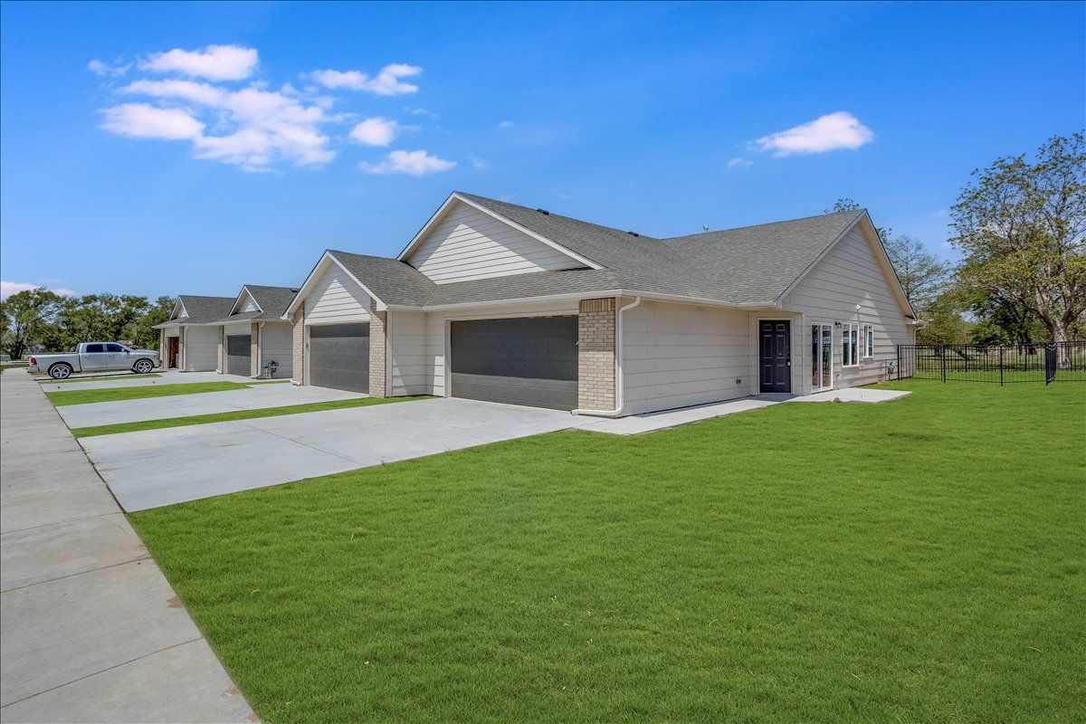 A house with a lot of grass in front of it.