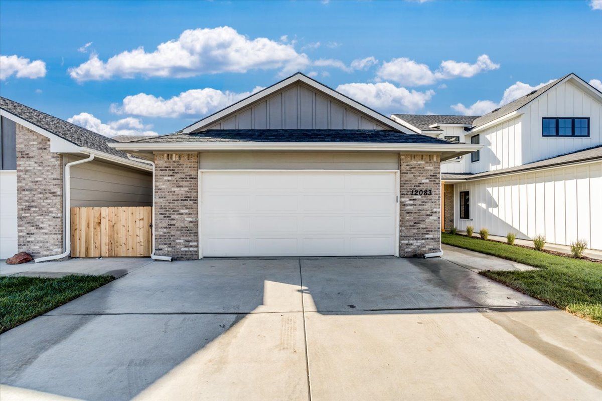 The front of a house with a white garage door