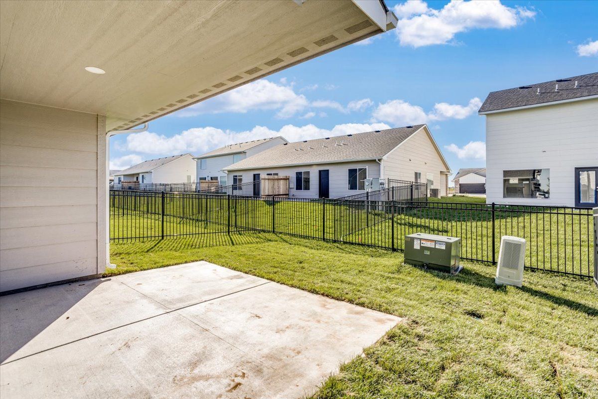 There is a fence around the backyard of a house.