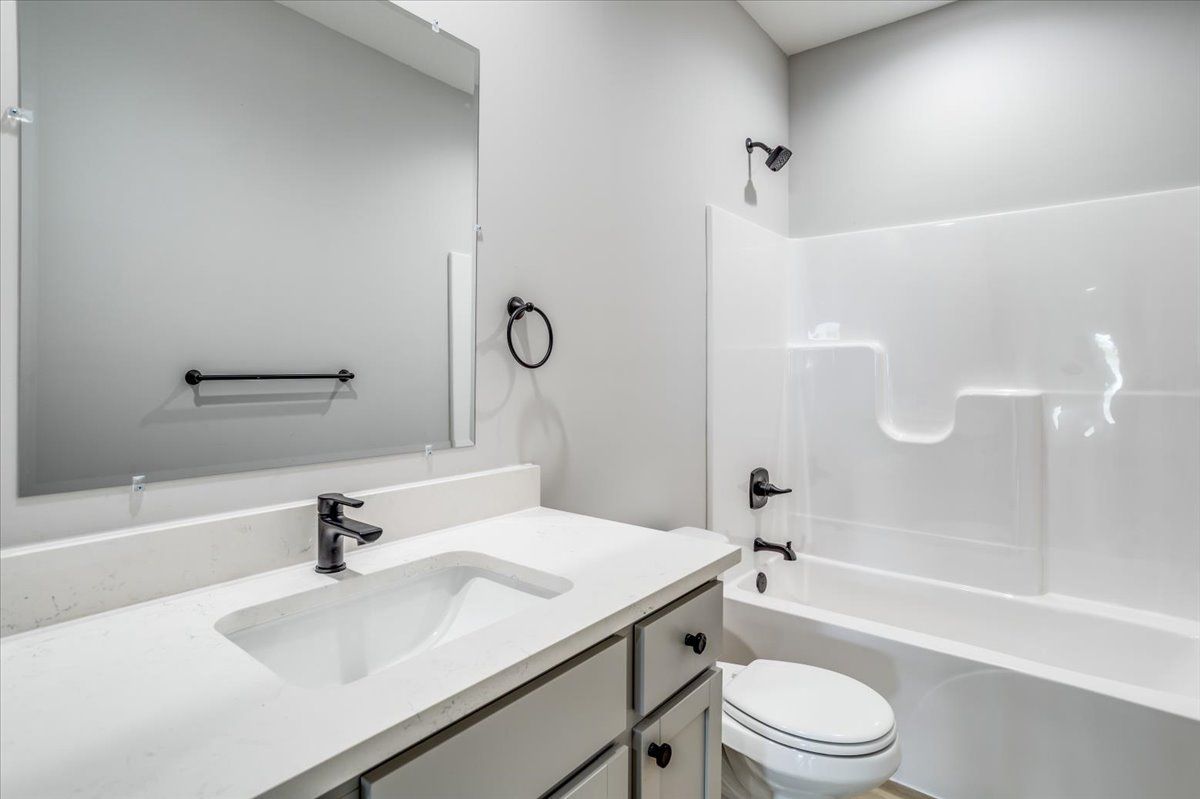 A bathroom with a sink , toilet , and shower.