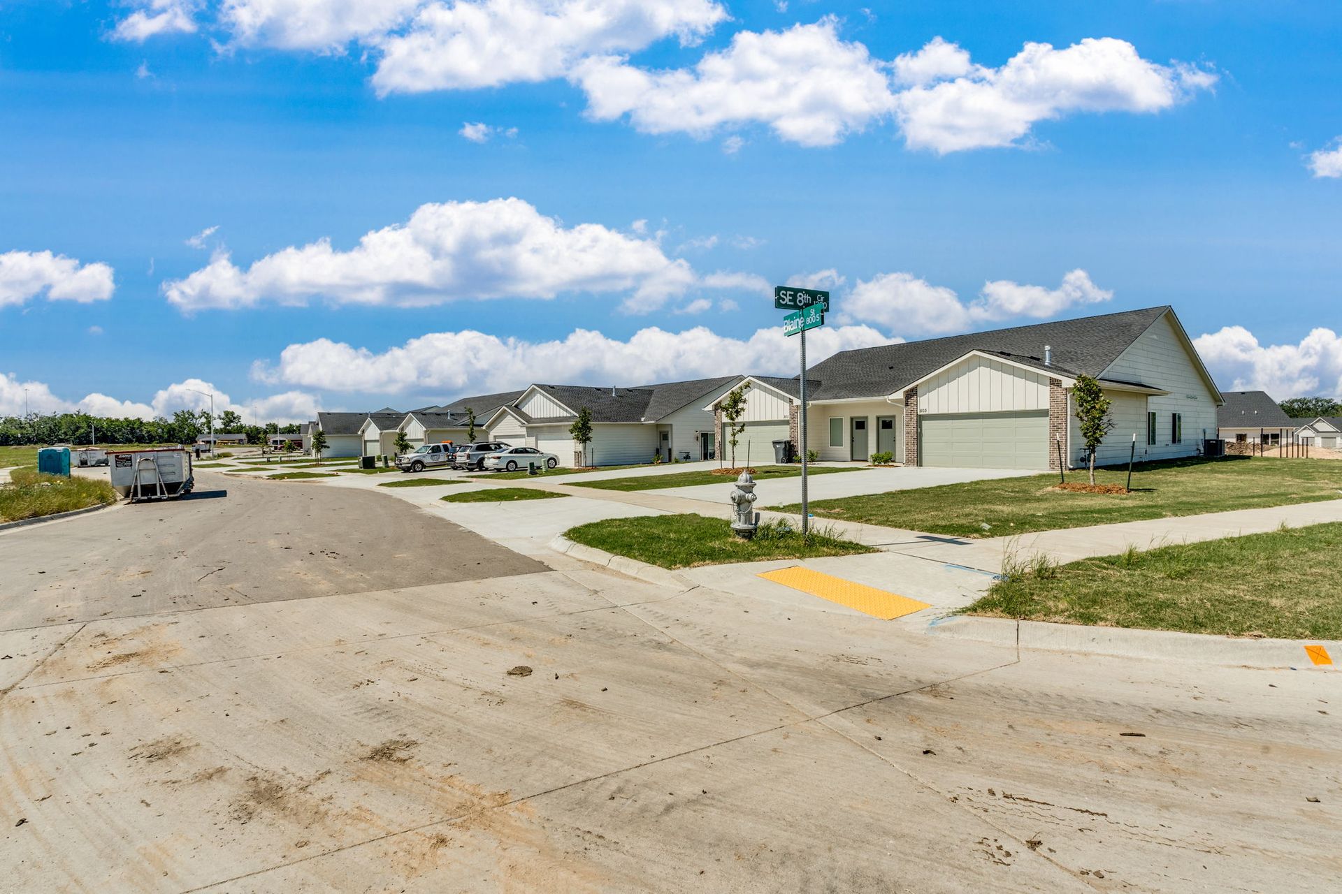 A row of houses with a fire hydrant on the side of the road.