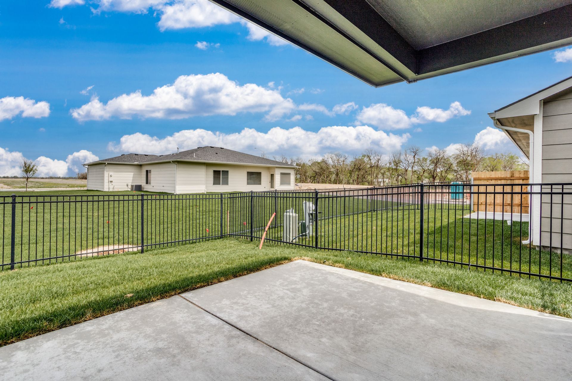 There is a fence around the backyard of a house.