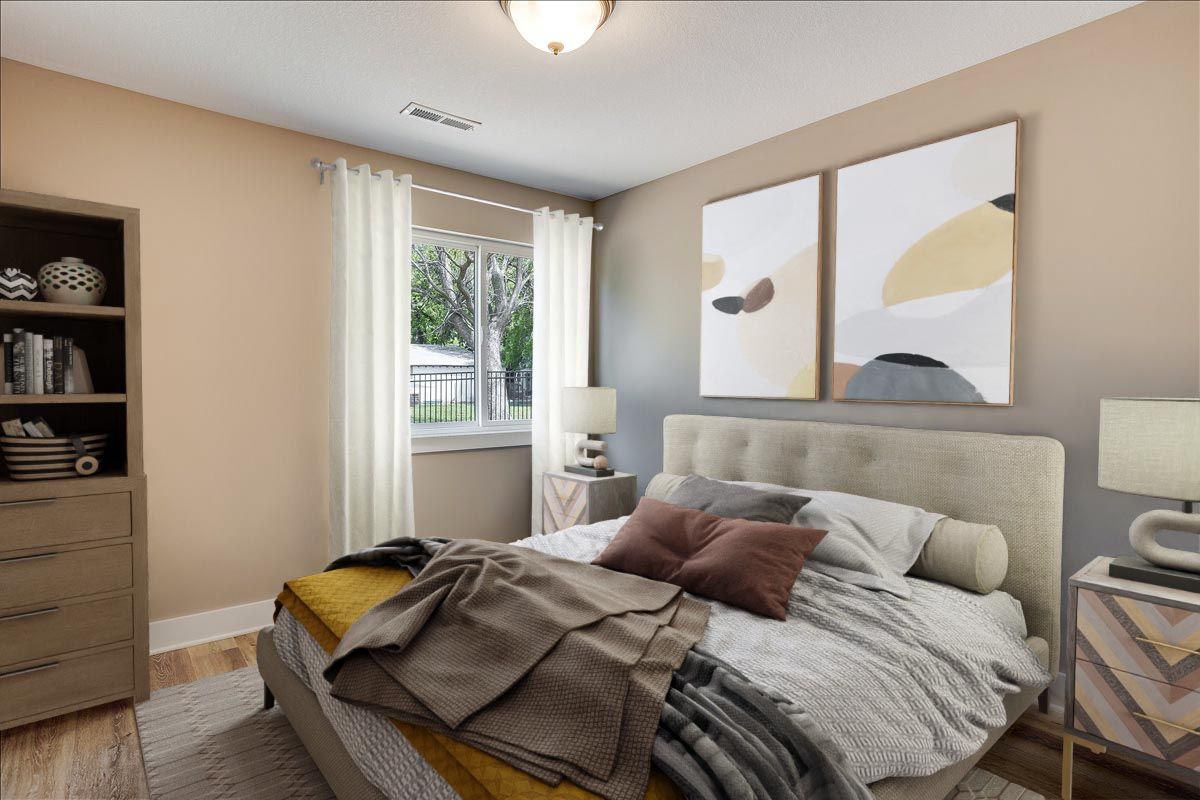 A bedroom with a bed , dresser , nightstand , and window.