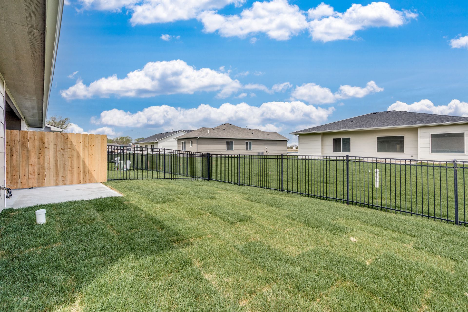 There is a fence in the backyard of a house.