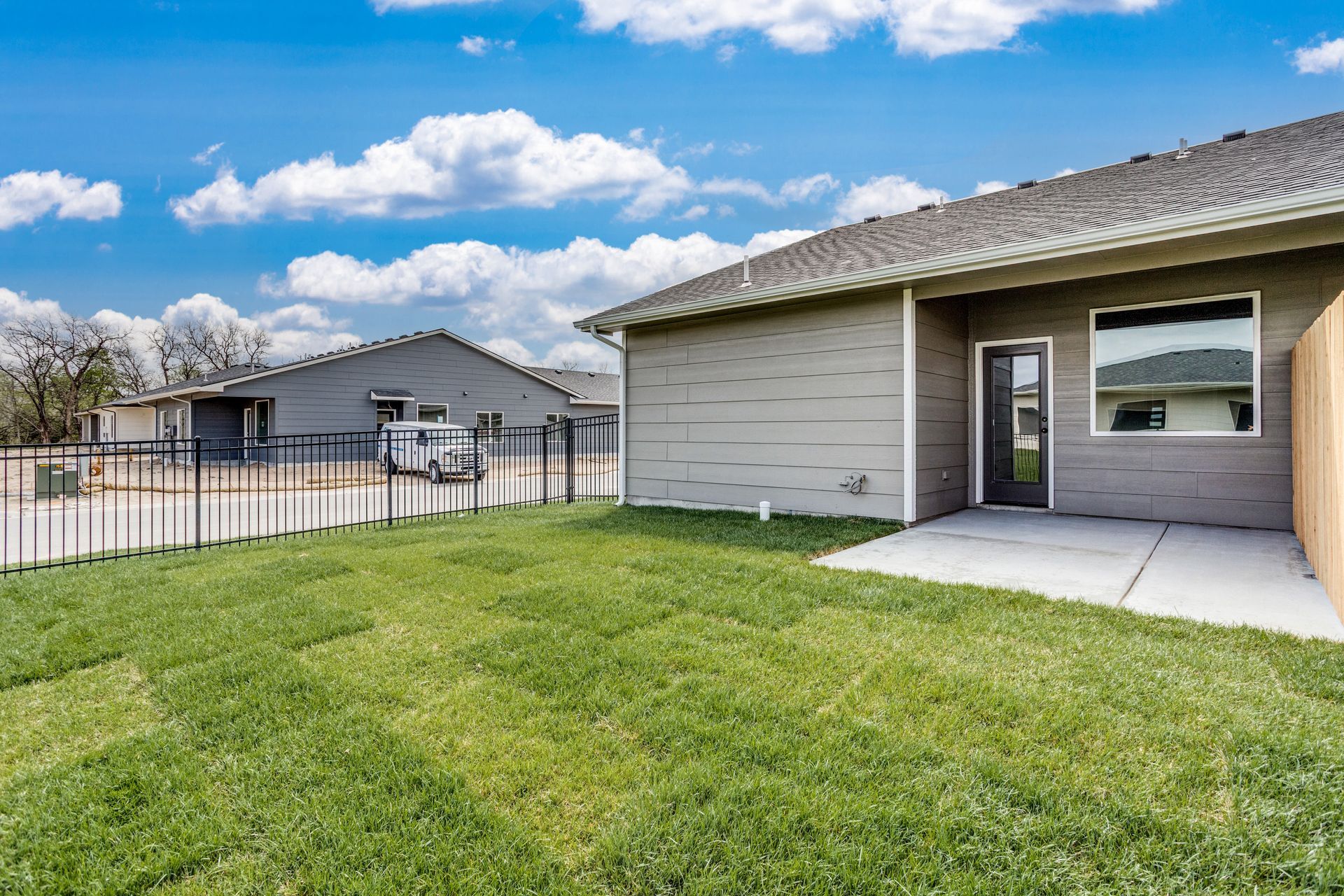 A house with a large lawn in front of it.