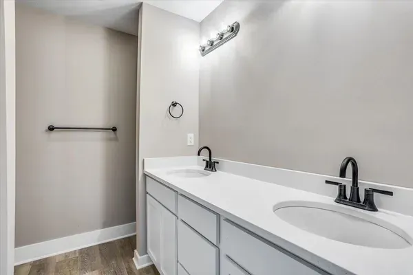 A bathroom with two sinks and a mirror.
