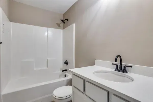 A bathroom with a sink , toilet , bathtub and shower.