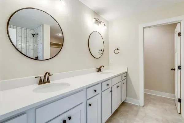 A bathroom with two sinks and two mirrors