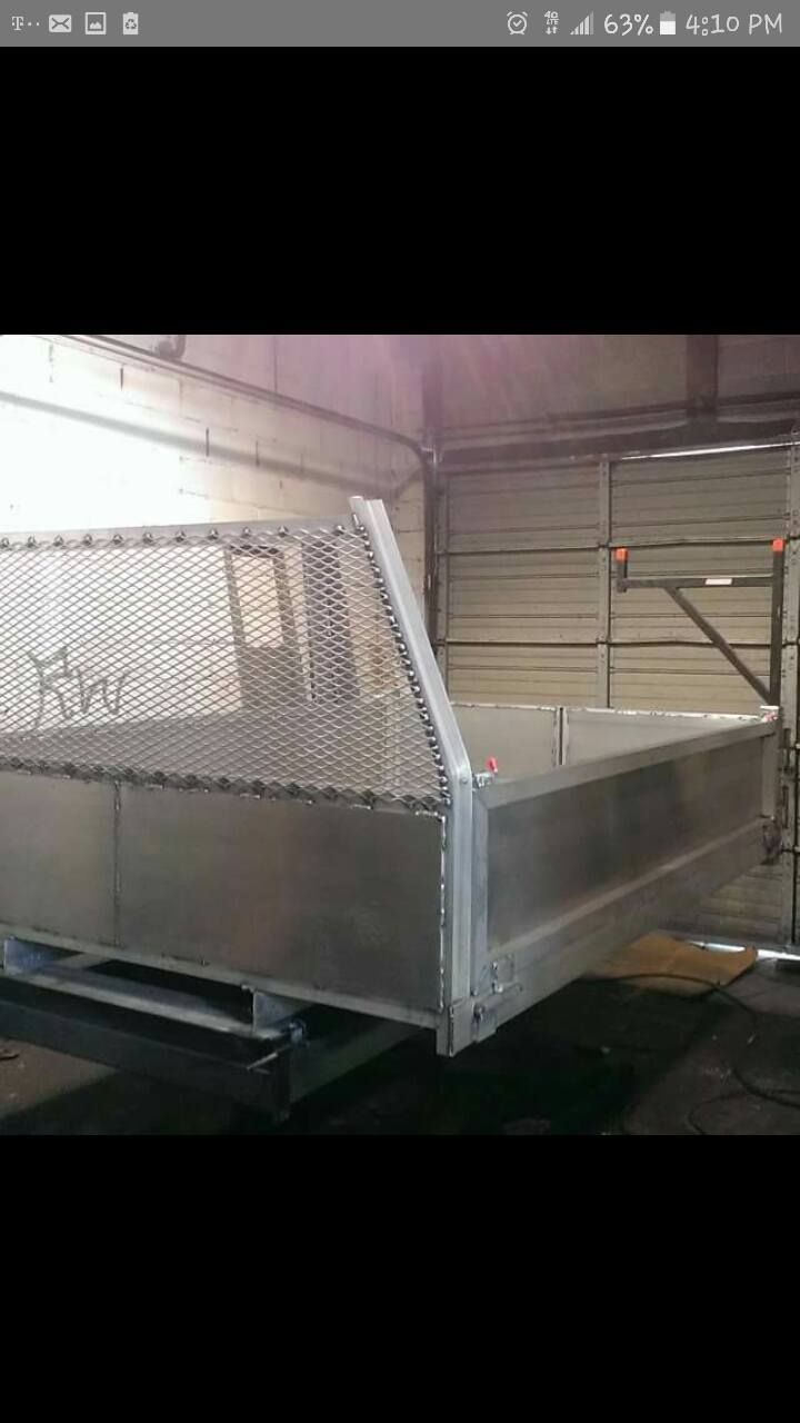 A metal tray is sitting in a garage next to a garage door.