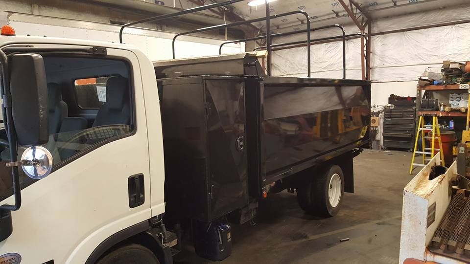 A dump truck is parked in a garage.