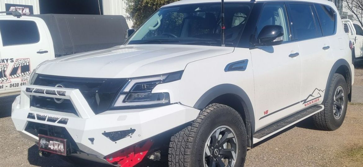 A White Nissan Patrol is Parked on the Side of the Road — Sparky's 4x4 Auto Electrical In Taminda, NSW