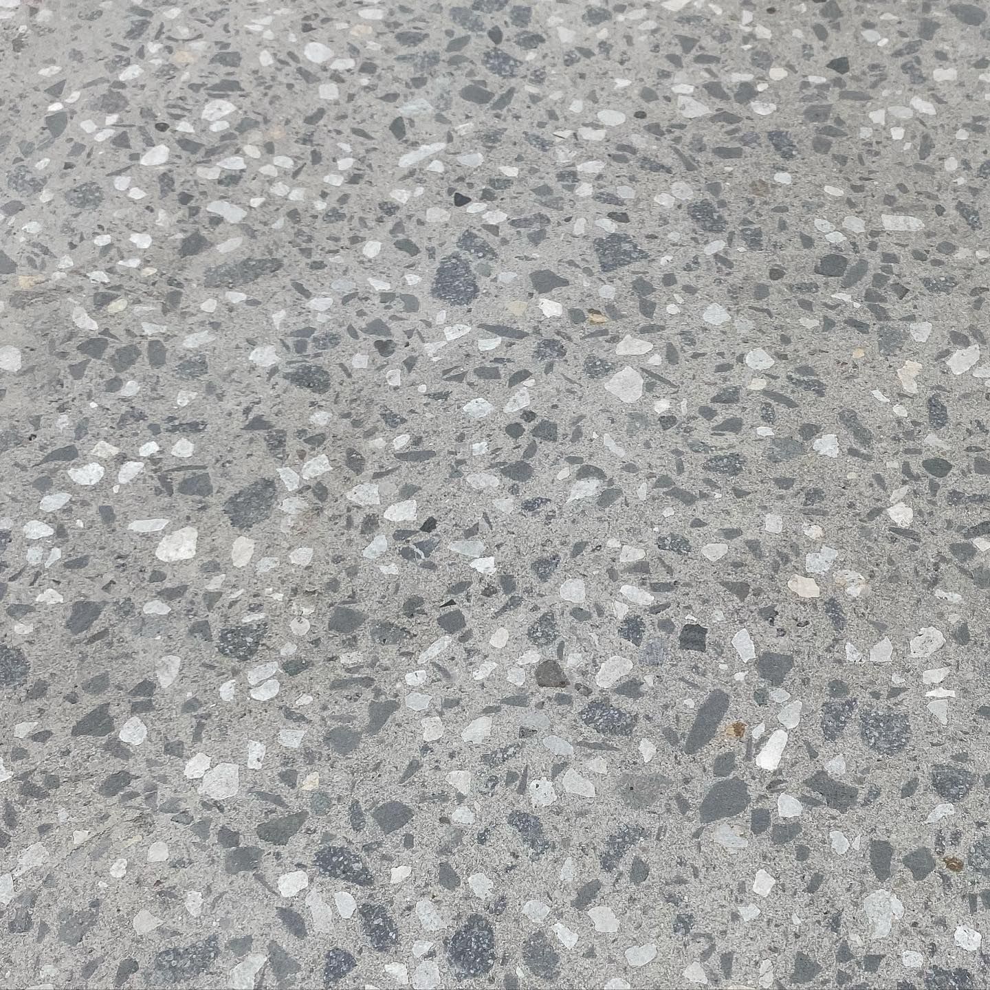 A close up of a gray and white terrazzo floor