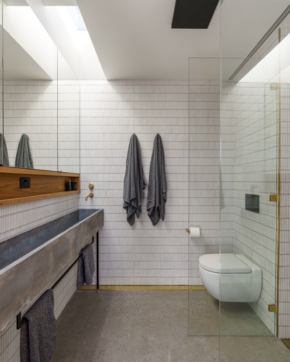 A bathroom with a toilet , sink and mirror