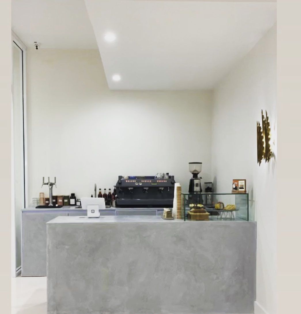 A kitchen with a counter and a coffee machine