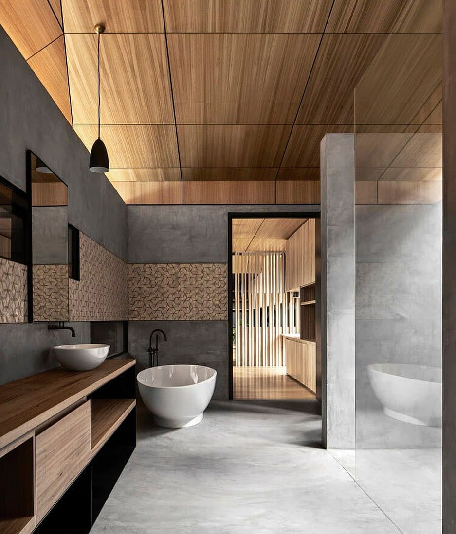 A bathroom with a bathtub and two sinks