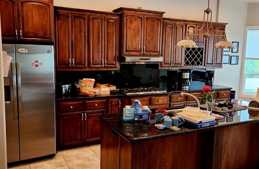 A kitchen with stainless steel appliances and wooden cabinets