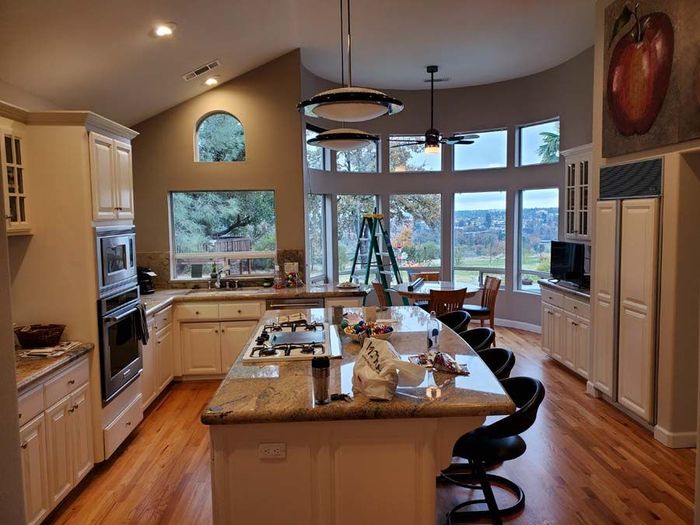 A kitchen with a large island in the middle of the room.