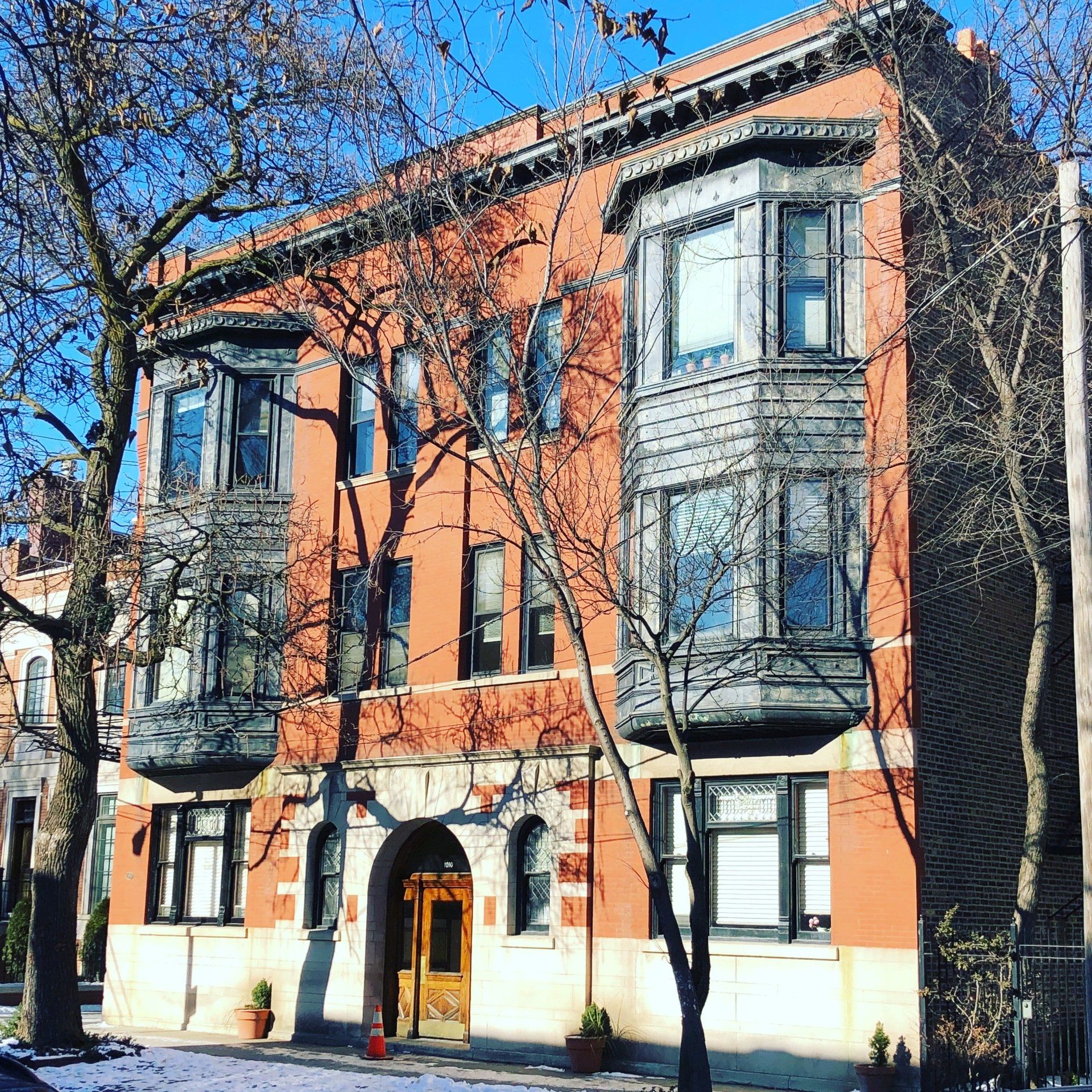 A large red brick building with trees in front of it
