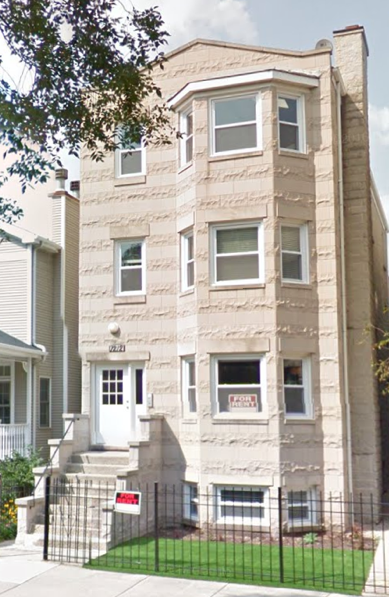 A building with a for sale sign in front of it