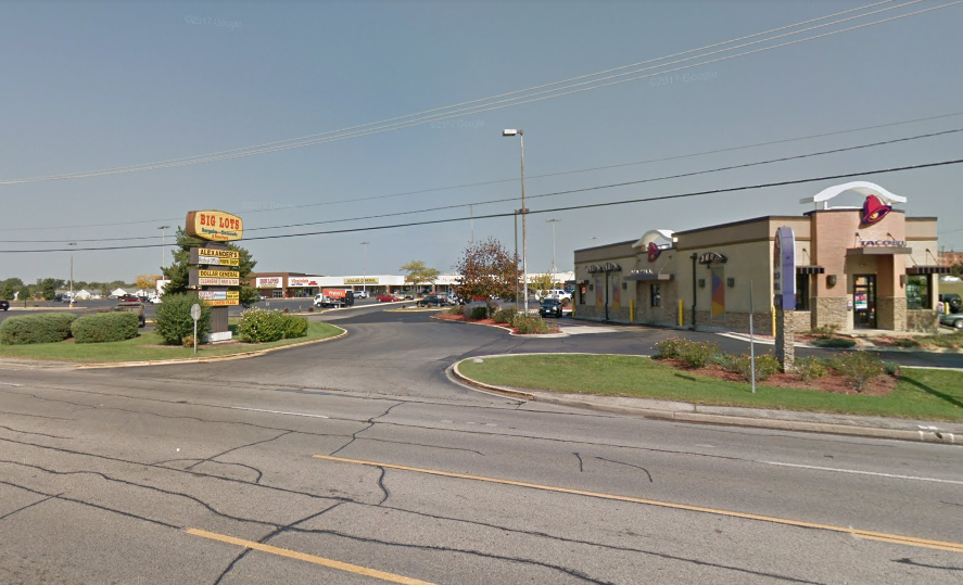 A corner of a road with a few buildings on it