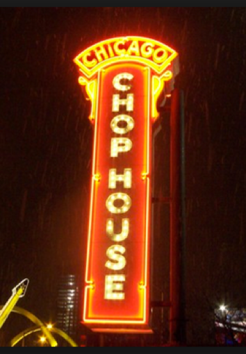A neon sign for chicago chop house is lit up at night