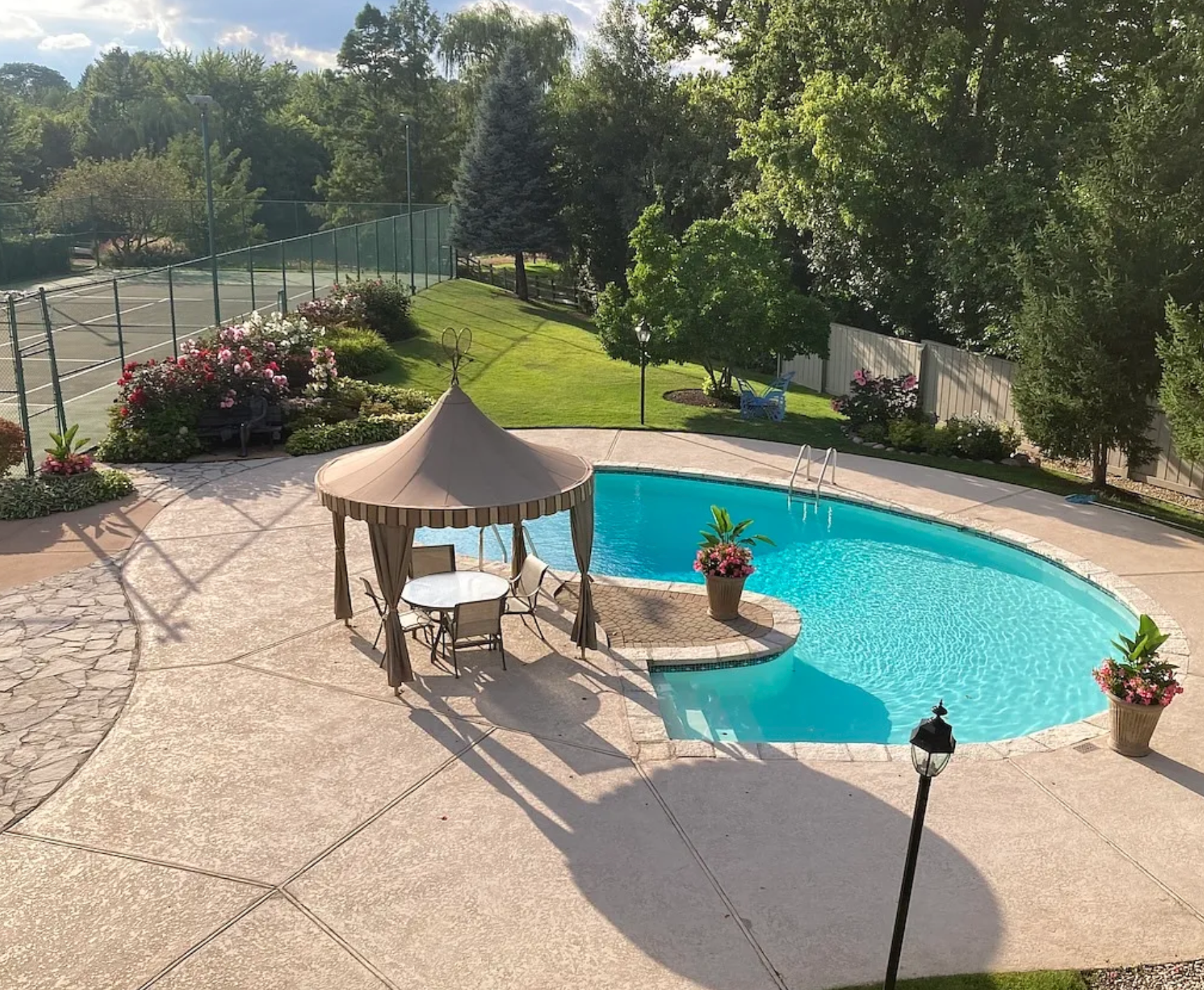 A street corner with a building in the background and a blue mailbox in the foreground.