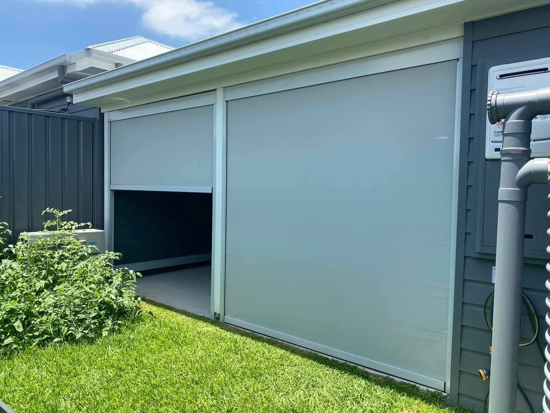 A house with a sliding screen door on the side of it.