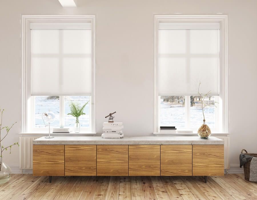 A living room with two windows and a wooden cabinet.