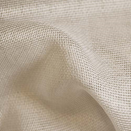 The sun is shining through a metal fence