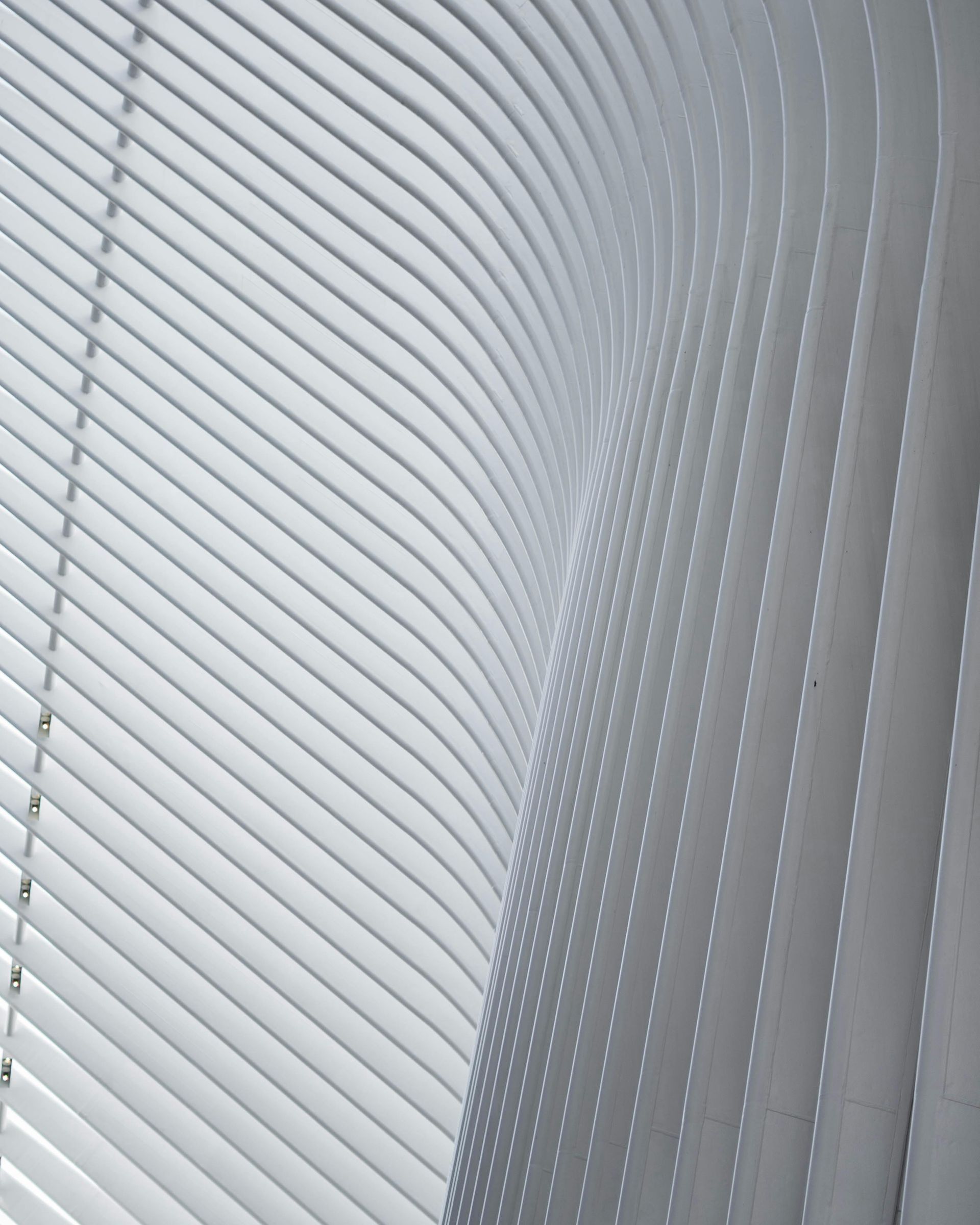 A bedroom with a bed , television , and sliding glass doors.