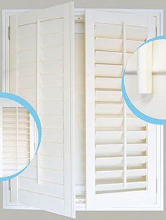A pair of white shutters on a window with blue circles around them.