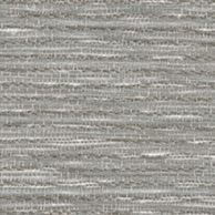 The sun is shining through a metal fence