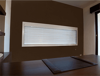 A living room with hardwood floors , chairs , a coffee table and a staircase.
