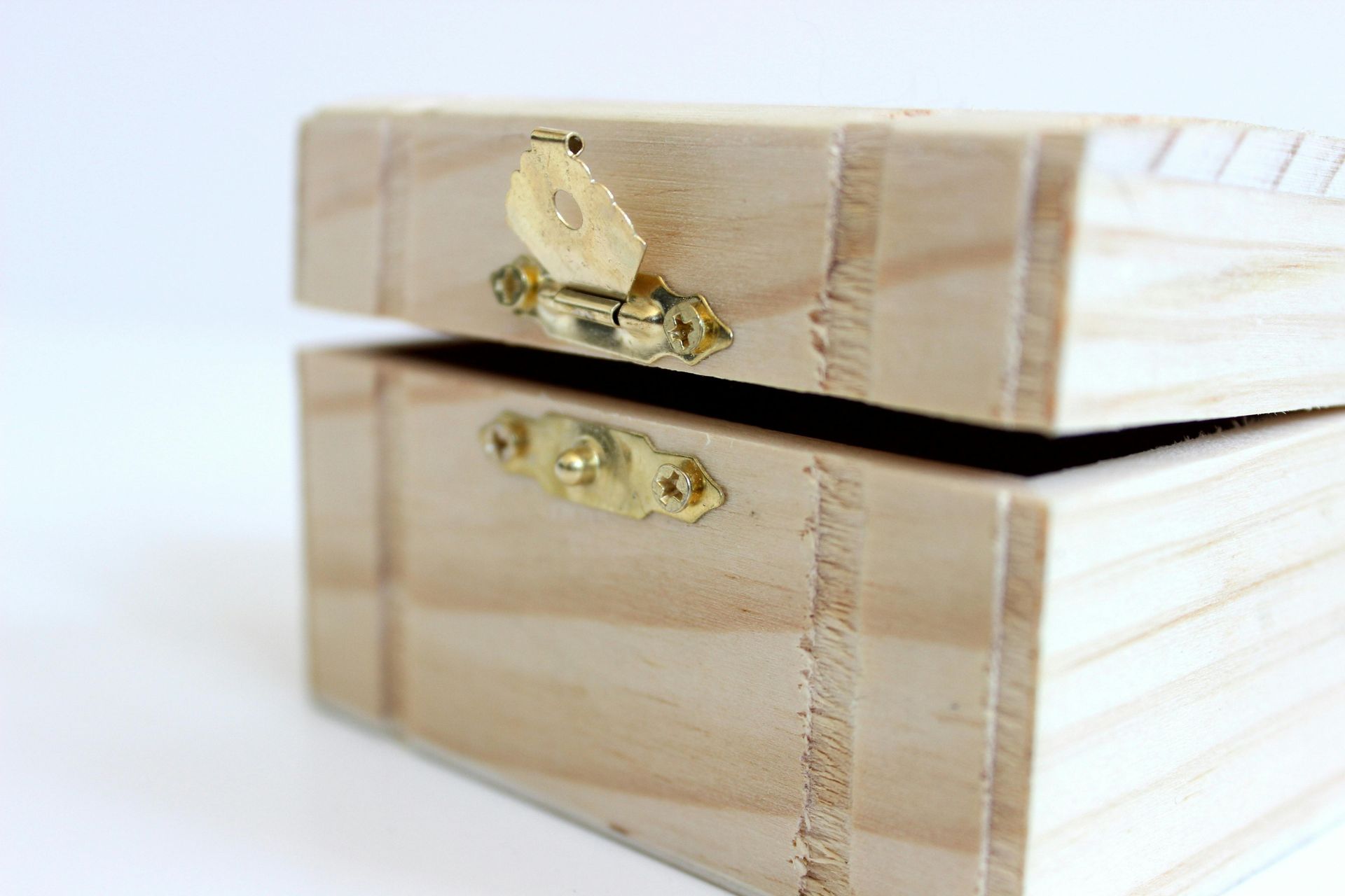 Wooden box with an open lid, showing a brass latch and hinges.