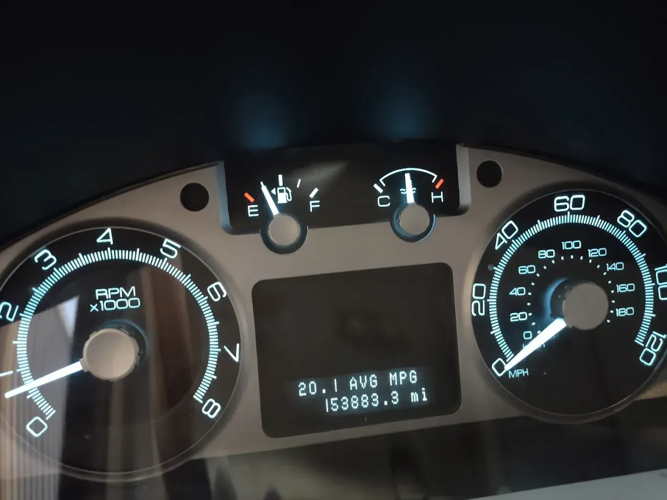 A close up of a car 's dashboard showing the rpm at 1000