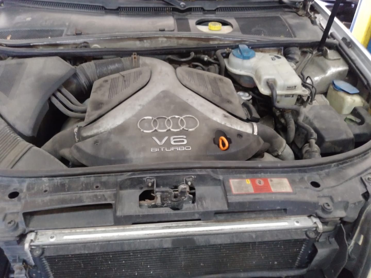 An audi v6 turbo engine is shown with the hood open
