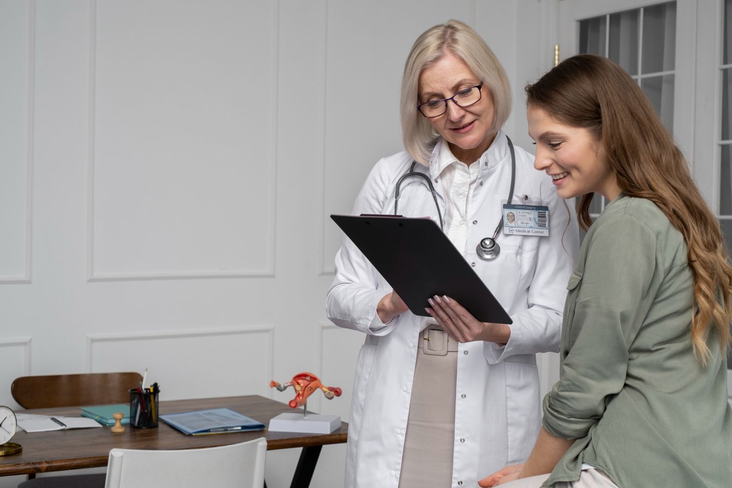 Doctor in white coat reviewing documents with patient in medical office.