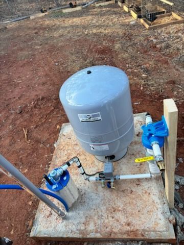 A water pump is sitting on top of a concrete platform.