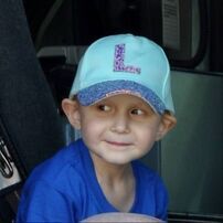 Boy wearing a light blue cap with 