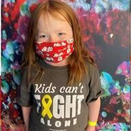 Girl wearing a mask and t-shirt that says 