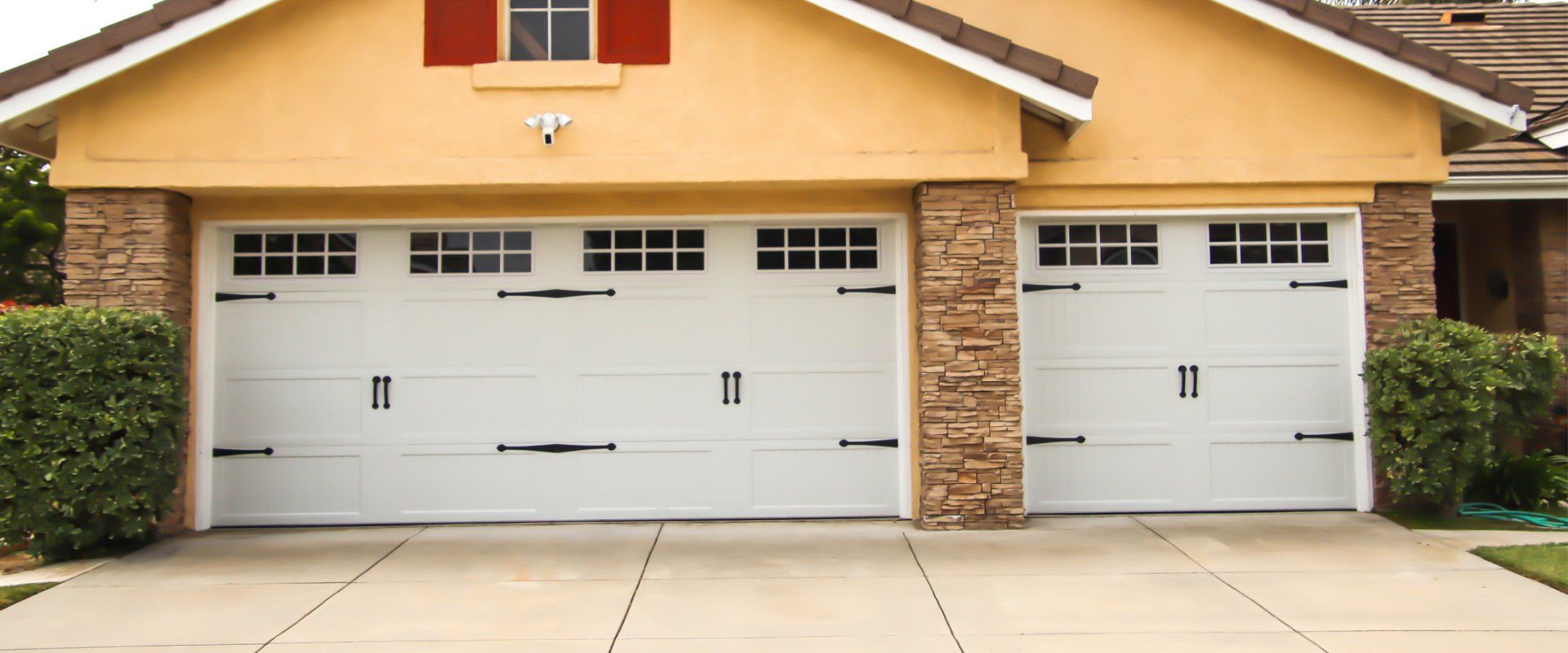 Home Exterior With Carriage Style Garage Doors — Everett, WA — Northwest Concrete & Landscape Specialty, LLC