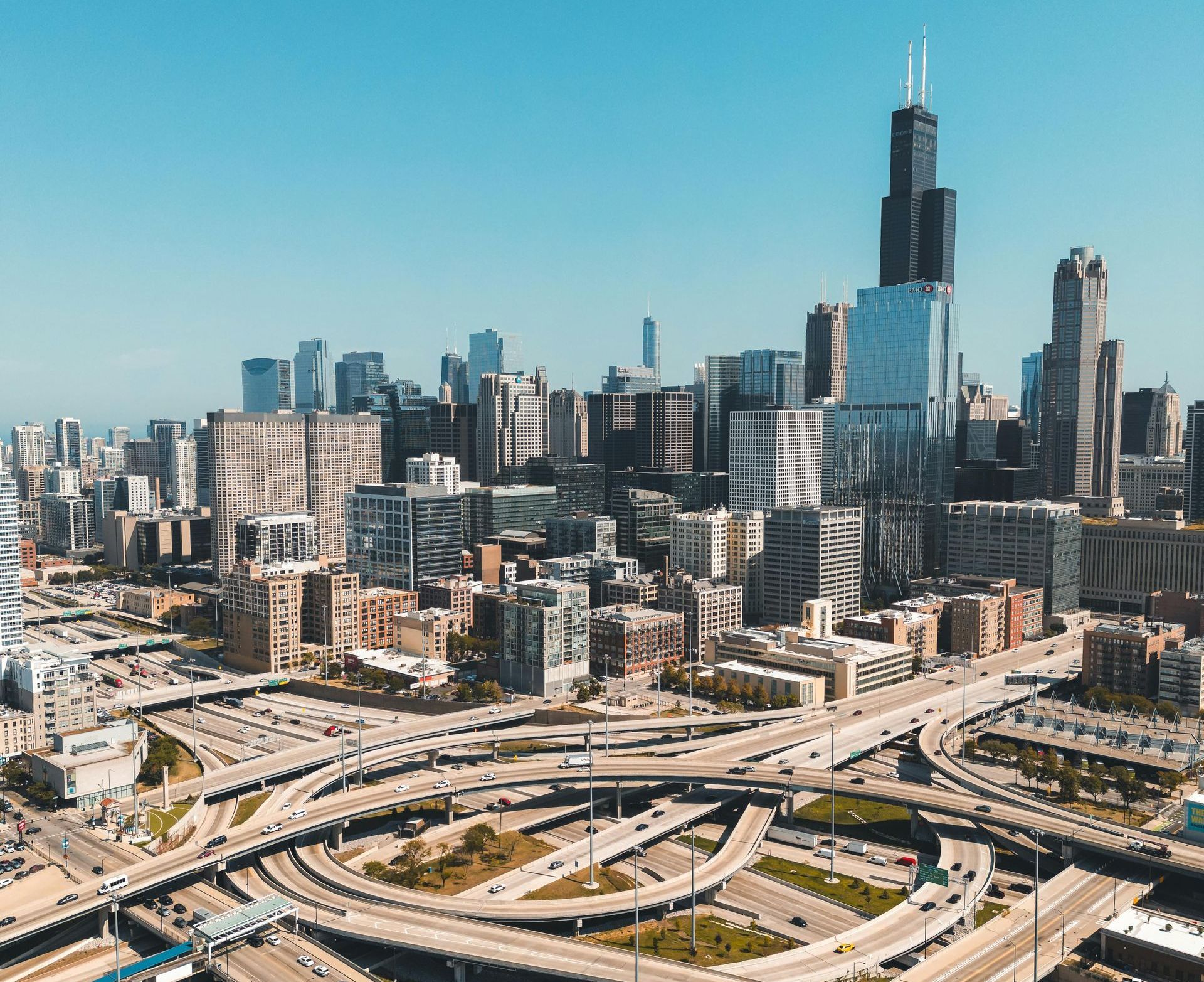 An aerial view of a city with a lot of highways and buildings.