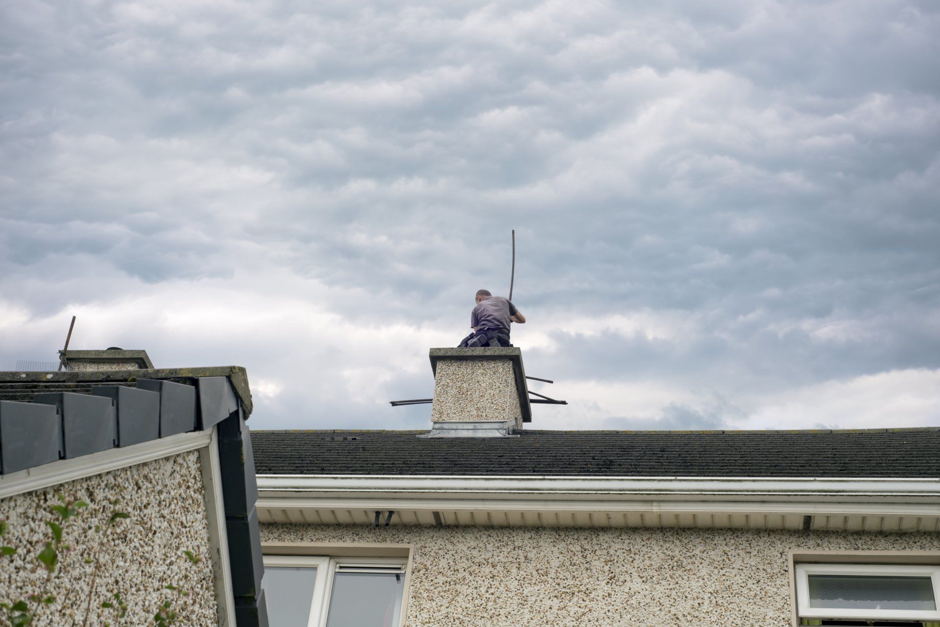 worker cleaning the chimney