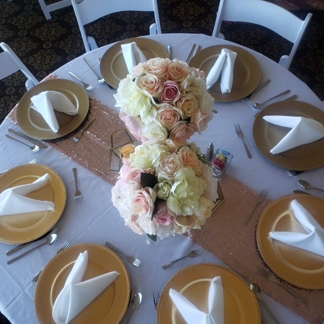 A table with plates and napkins and flowers on it