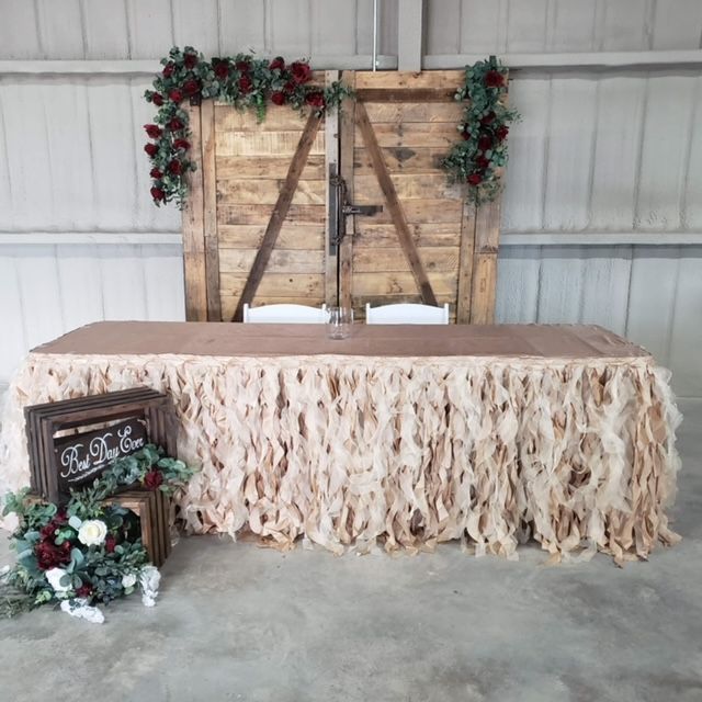 A table with a table cloth and a sign that says love